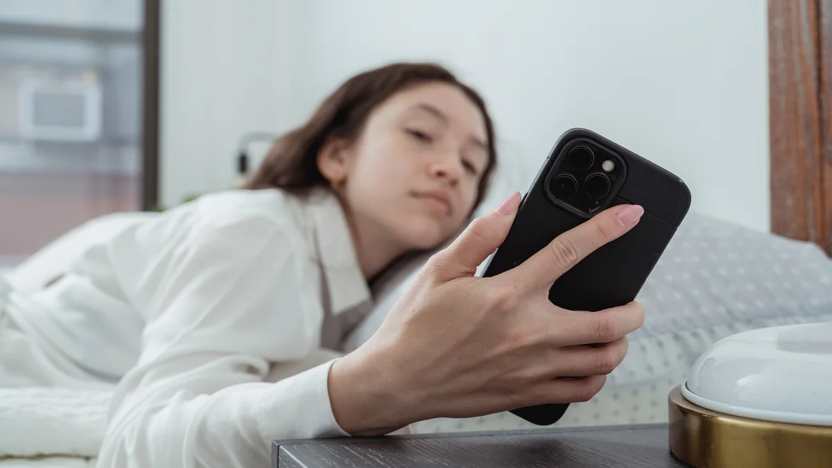 Person checking a smartphone with many unread group chat messages