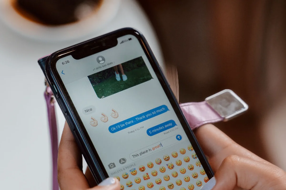 Close-up of a person checking a text message on a smartphone.