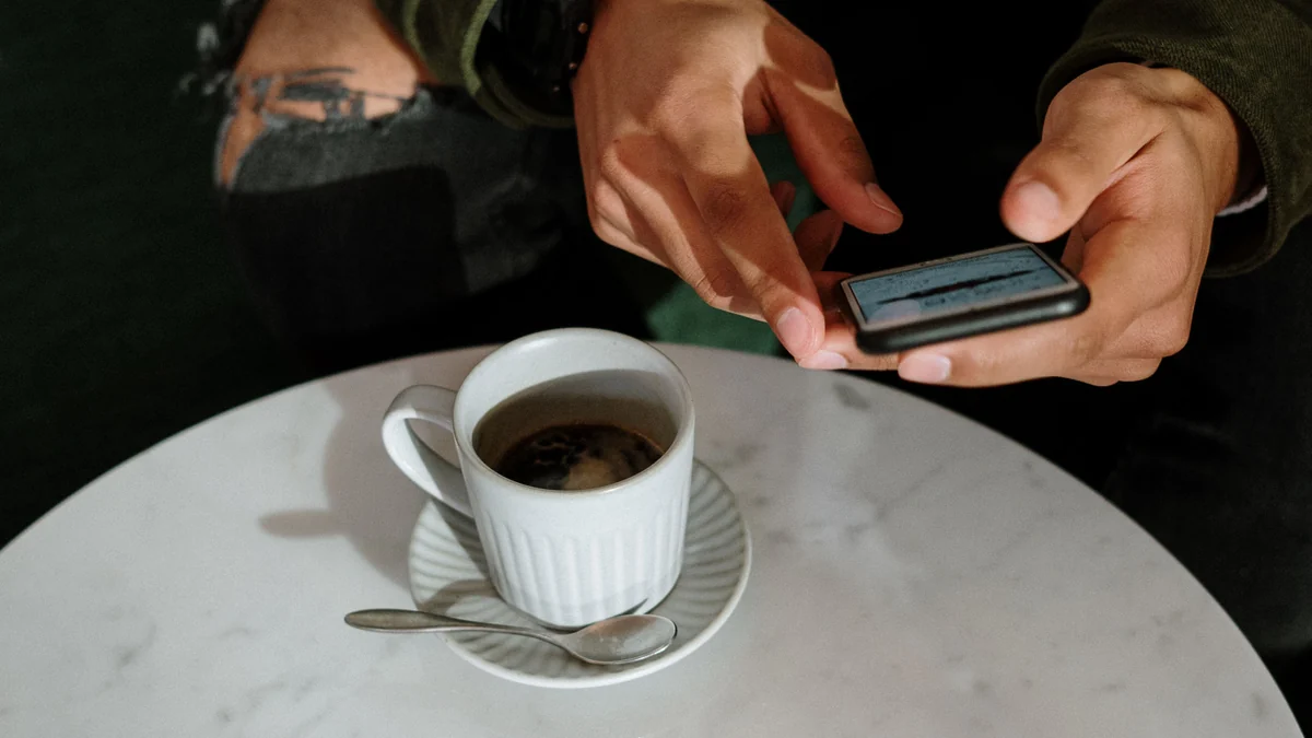 Person checking a phone while waiting for a reply