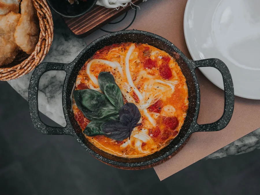 Shakshuka with eggs cooked in tomato sauce.