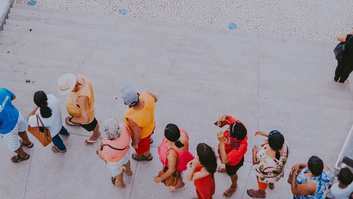 People waiting in a line while someone moves ahead