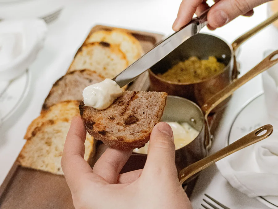 Toast being spread with butter.
