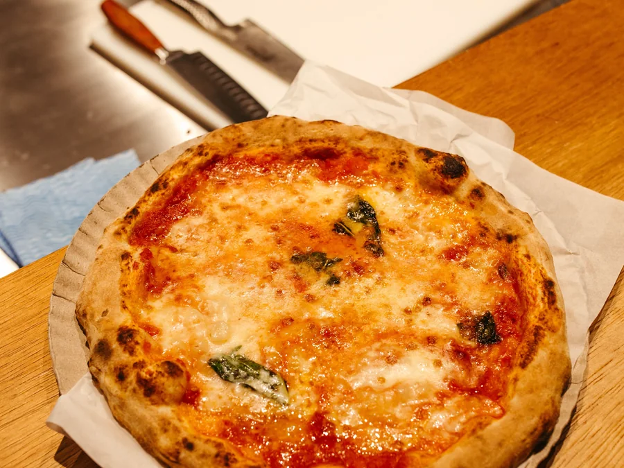 Classic Margherita pizza with tomato, mozzarella and basil.