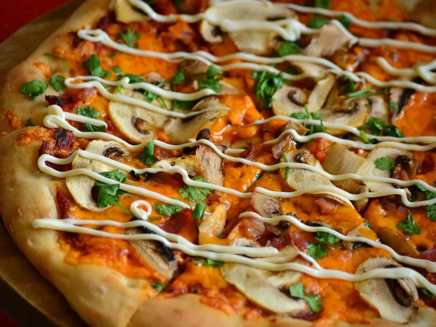 Mushroom pizza topped with sliced mushrooms.