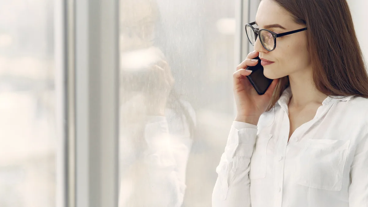 Thoughtful person checking a phone while waiting for a usual quick reply