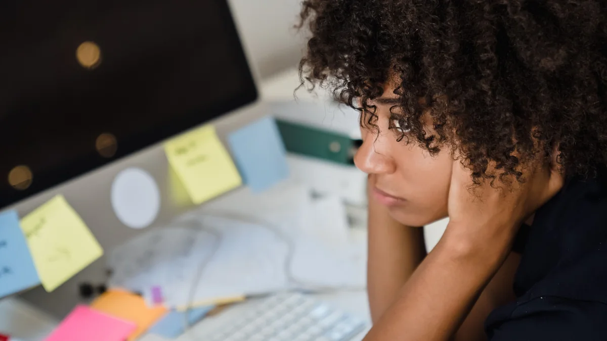 Busy person working with many notes and tasks at a desk