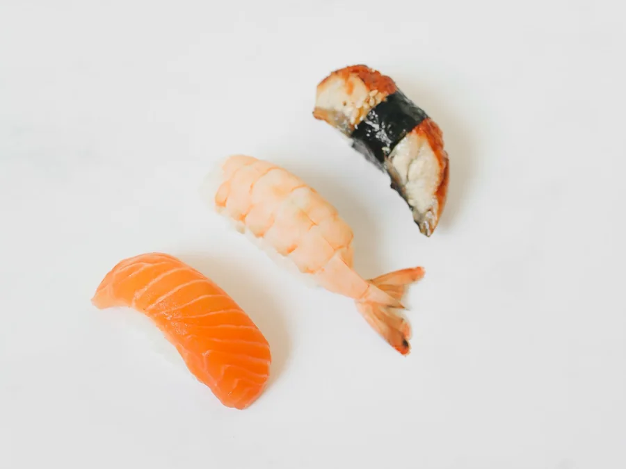 Assorted nigiri sushi including salmon and other seafood.