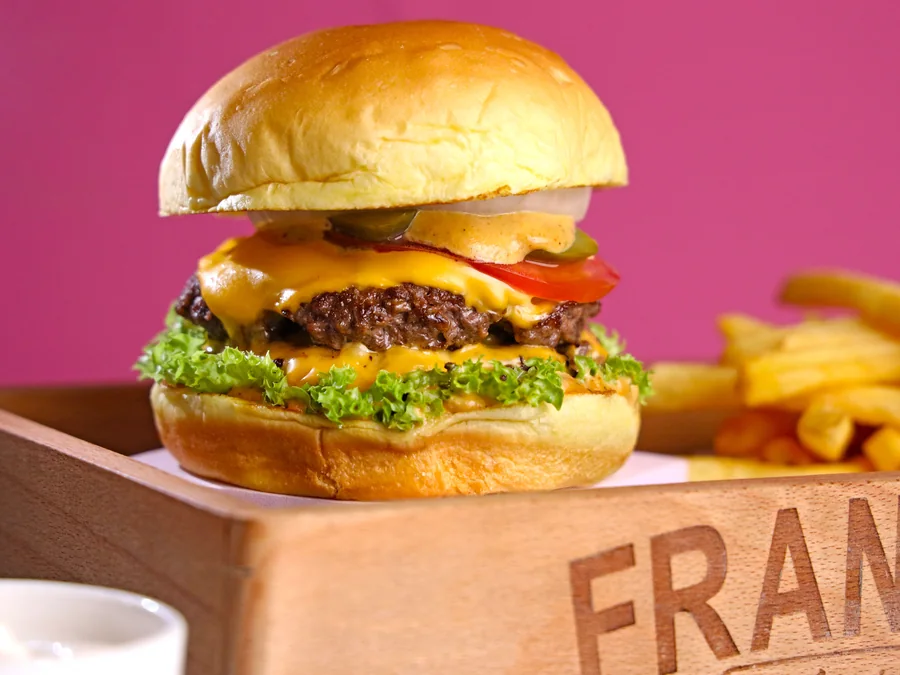 Classic cheeseburger with cheese and familiar toppings.