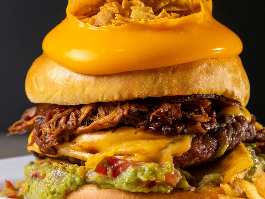 Loaded gourmet burger with multiple toppings.