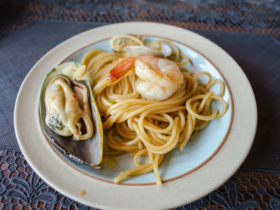 Seafood pasta served with shellfish.