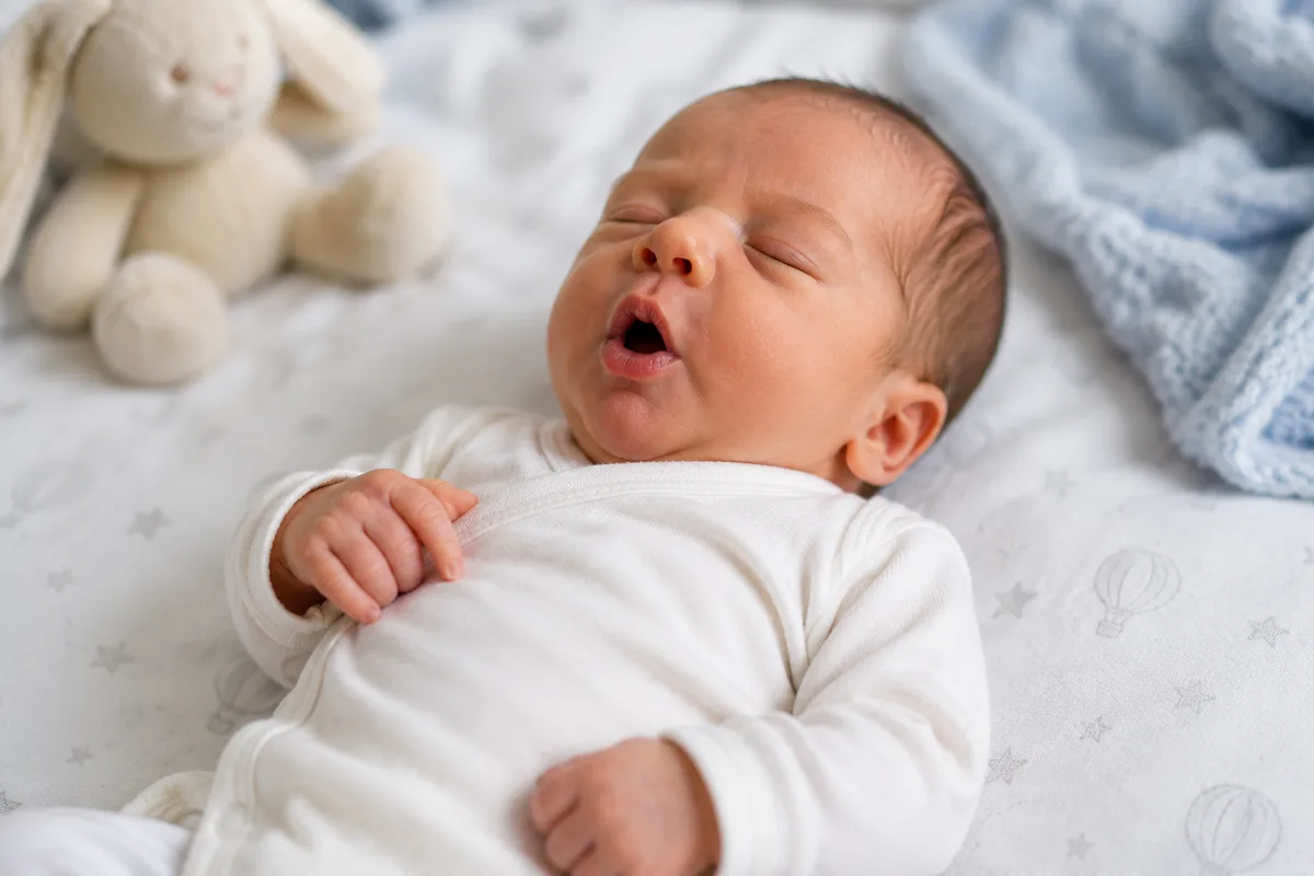 Newborn baby lying comfortably while experiencing hiccups