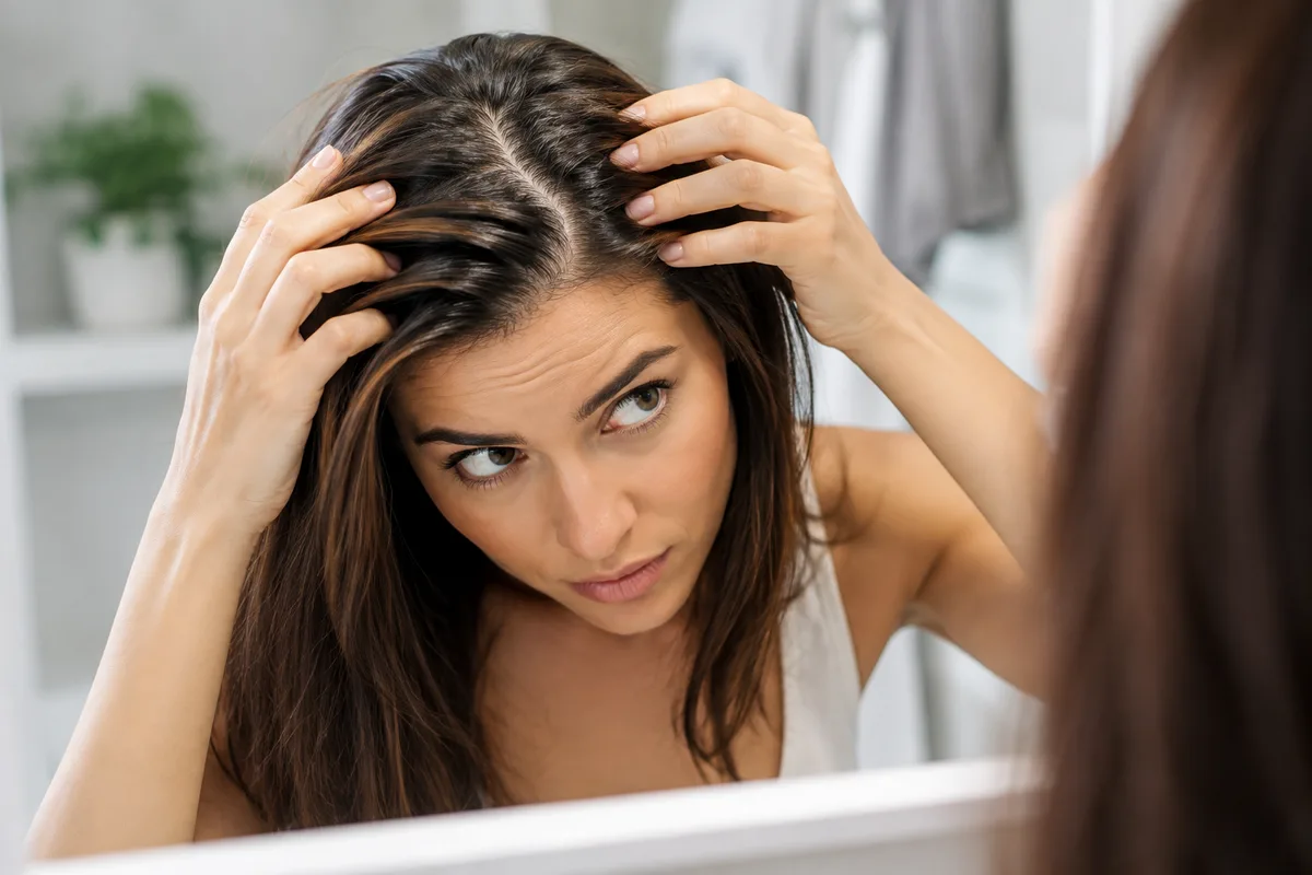 Close-up view of hair roots showing natural oil buildup near the scalp